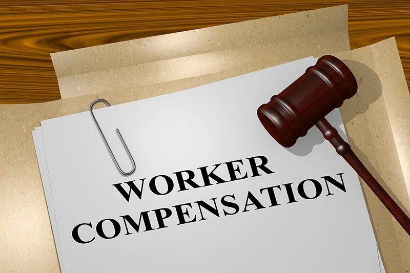 Worker compensation document with a gavel, symbolizing legal assistance for workplace injury claims and personal injury law.